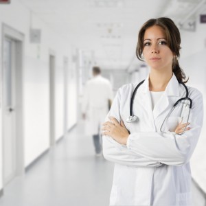 cute brunette in medical gown  and a stethoscope in an hospital